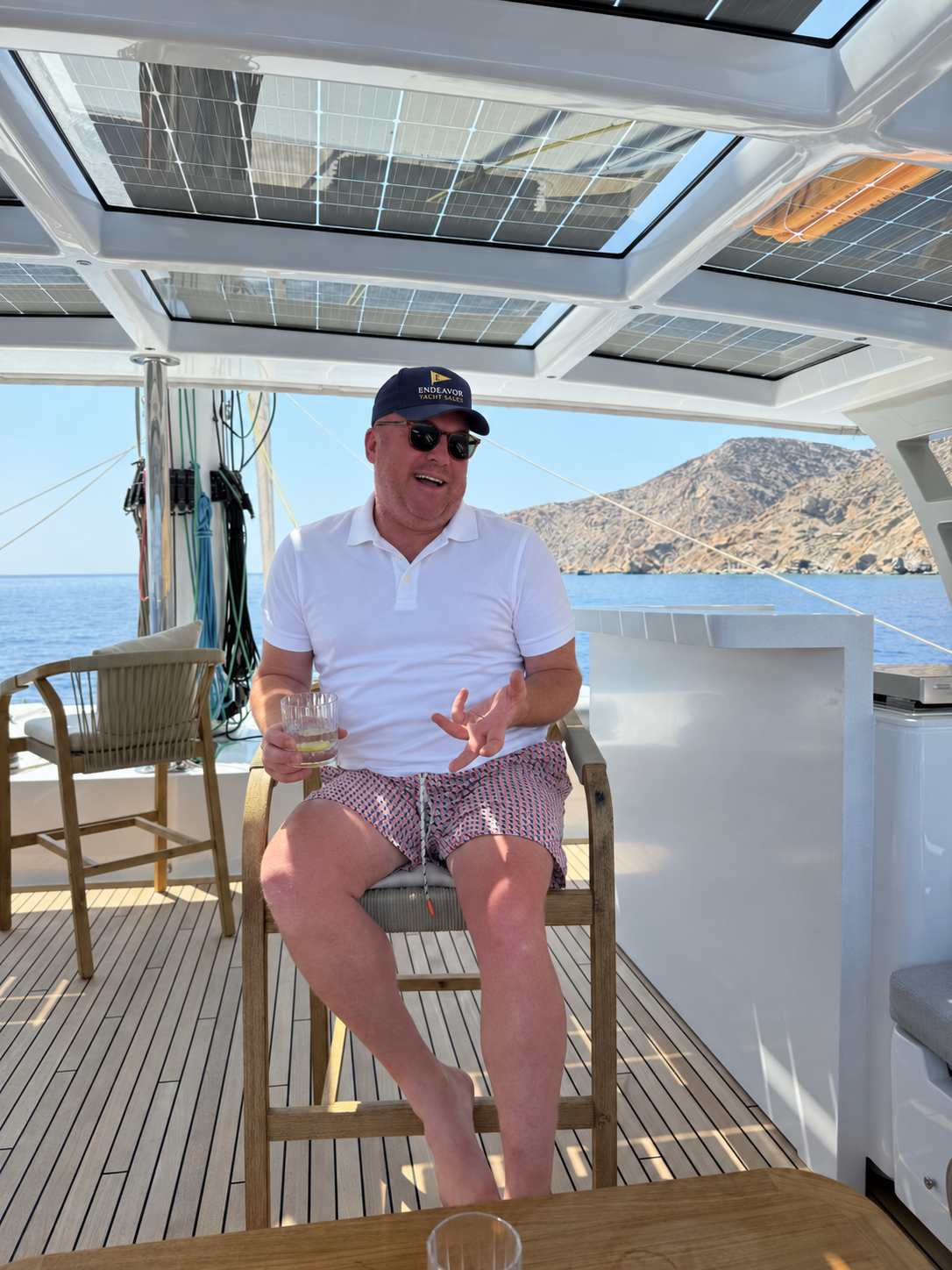 Jason Armstrong seated aboard a sailing catamaran